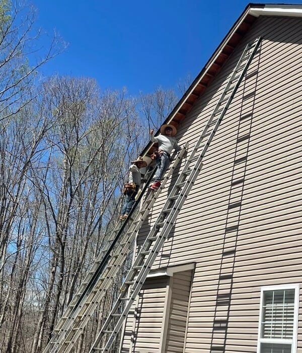 K&J Employees on ladders on side of home